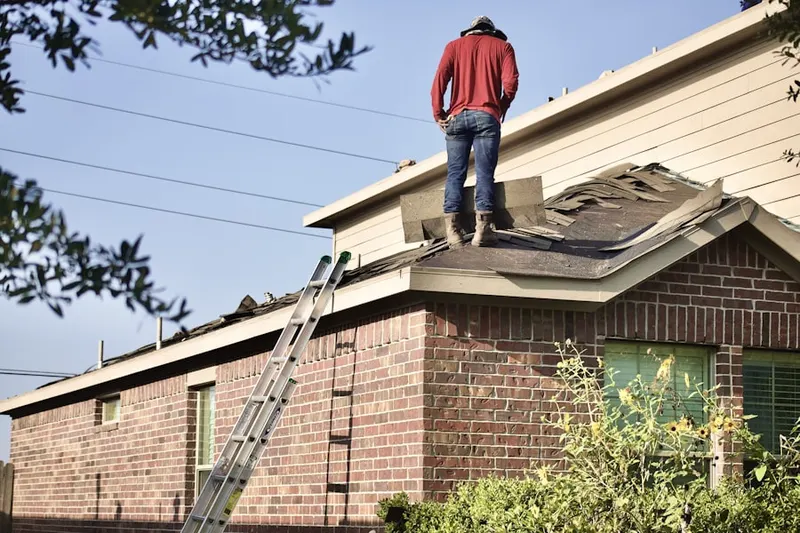 Professional roofer working on a residential roof in Savanna West